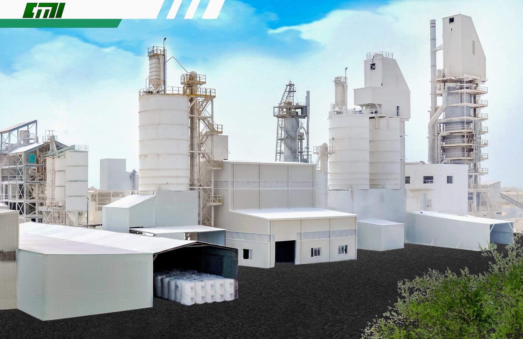 White silos and industrial structures at CMI's Sohar plant in Oman, with staircases and platforms under a clear blue sky.